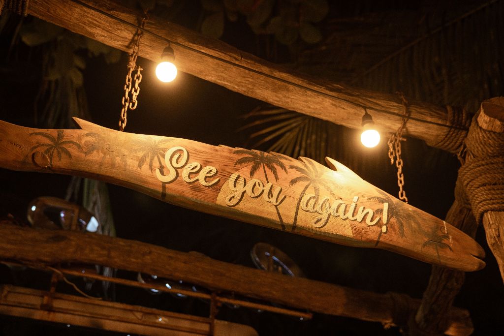 See You Again wooden surfboard sign with palm tree carvings