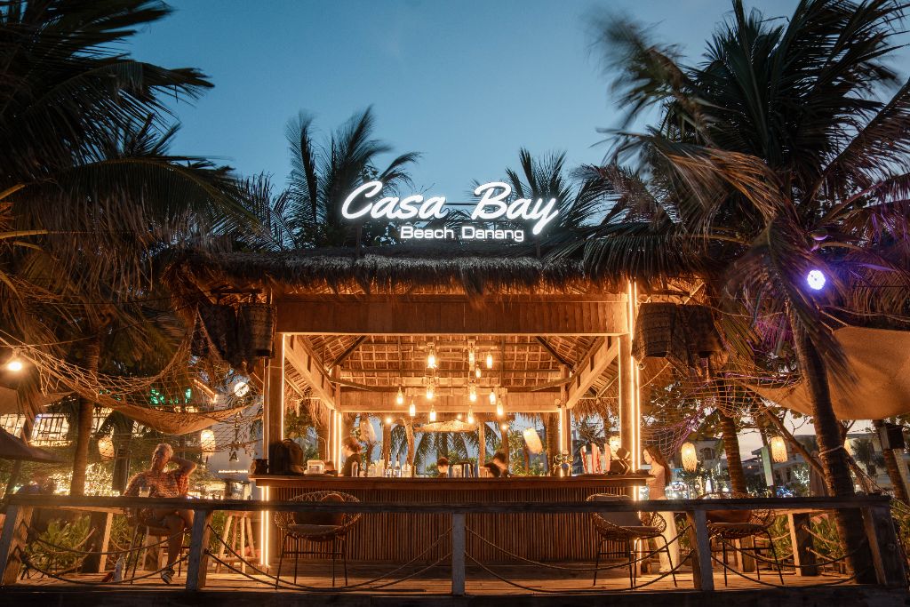Casa Bay Beach Club at night with glowing neon sign